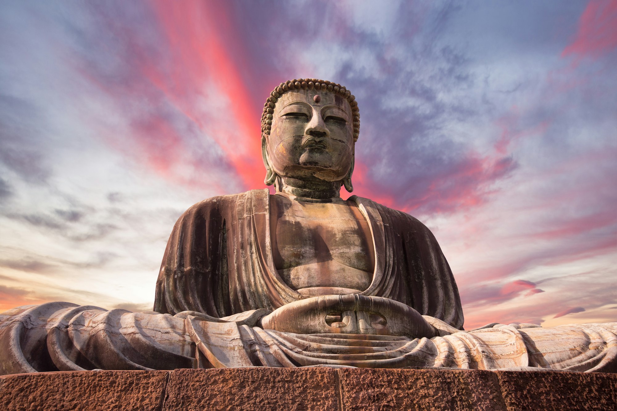 Giant Buddha statue under at sunset